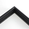 Simple tiered 1 " black floater. This thin, stepped floater is stained solid black. The top edge has an angled inner corner, sloping towards the contents of the frame. The surface has a wood grain texture.